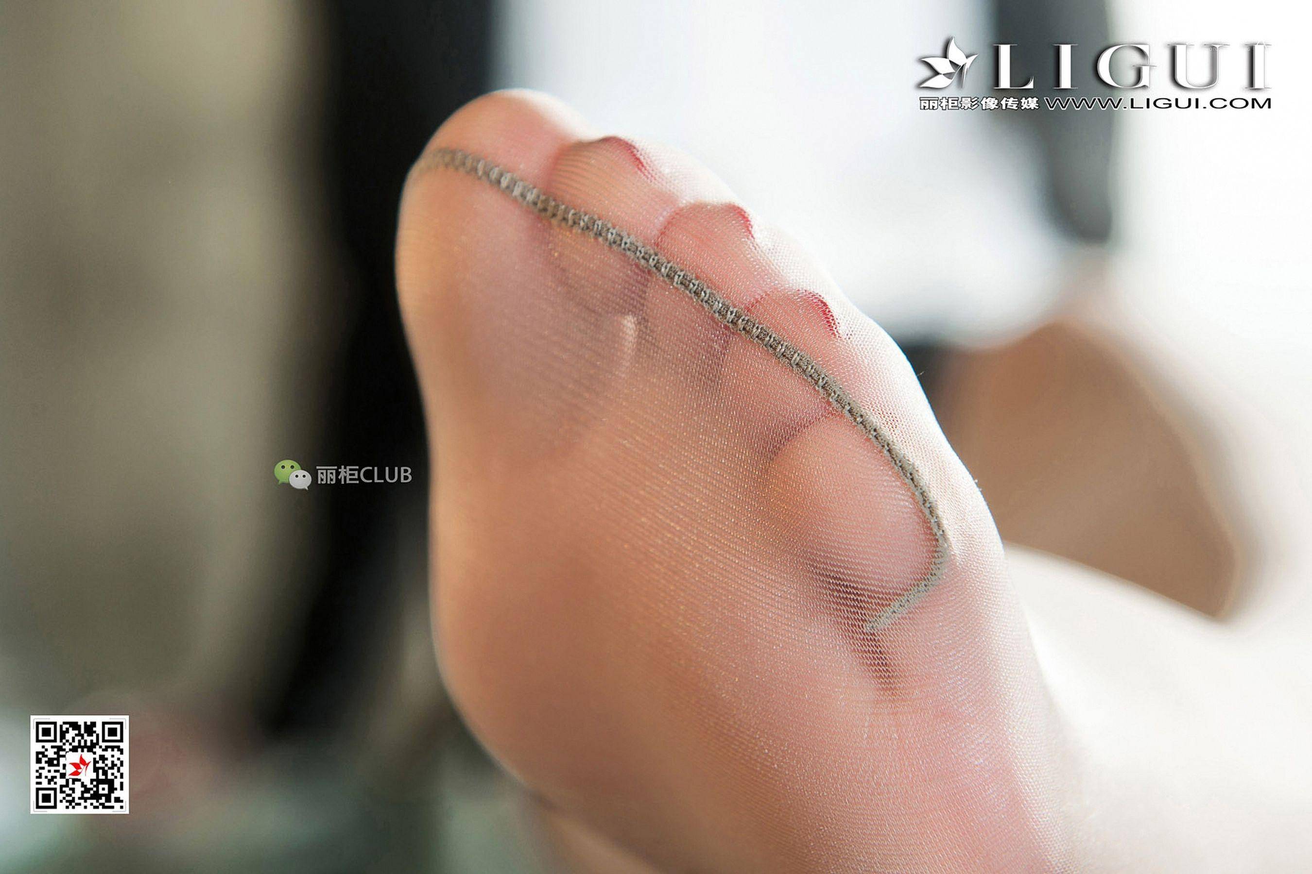 Close-up of a woman's foot in sheer stockings, showcasing the delicate texture and subtle details of the fabric.